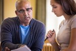 Two educators look over bargaining proposals together.