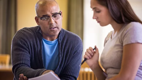 Two individuals discussing a document